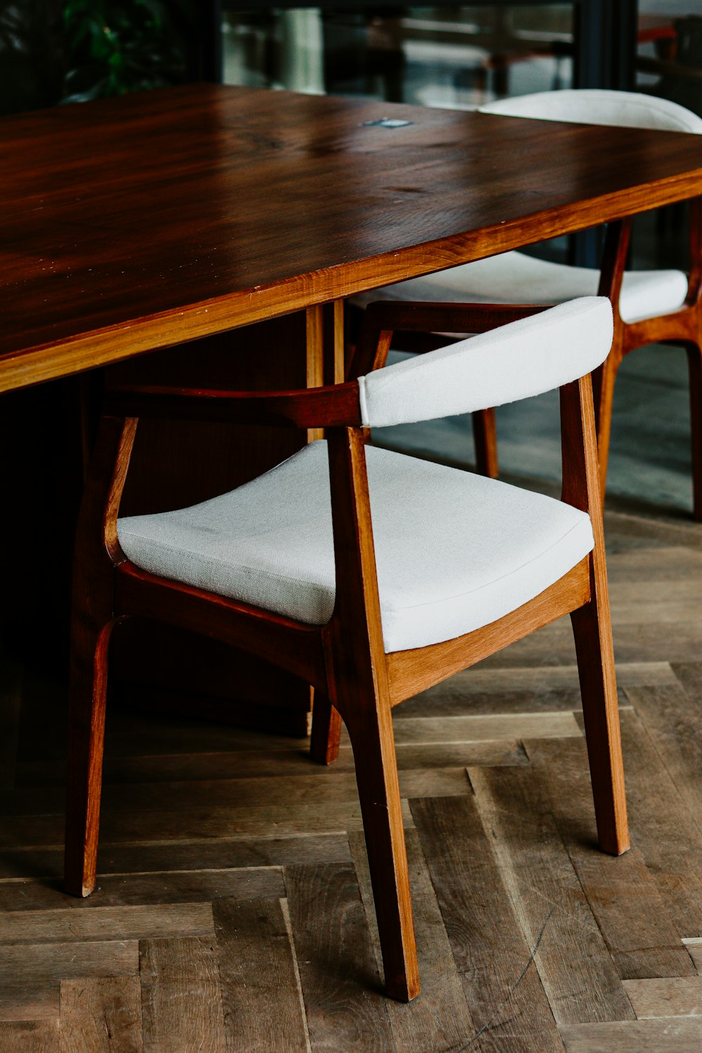 brown wooden table with white and brown chair