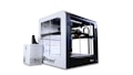 A large, modern 3D printer with a clear enclosure and a sleek design is accompanied by a separate unit. It features visible components and intricate mechanical parts within its transparent casing, highlighting its functionality.