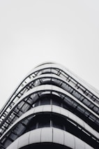 A sleek hotel building adjacent to a cargo facility, showcasing modern architecture.