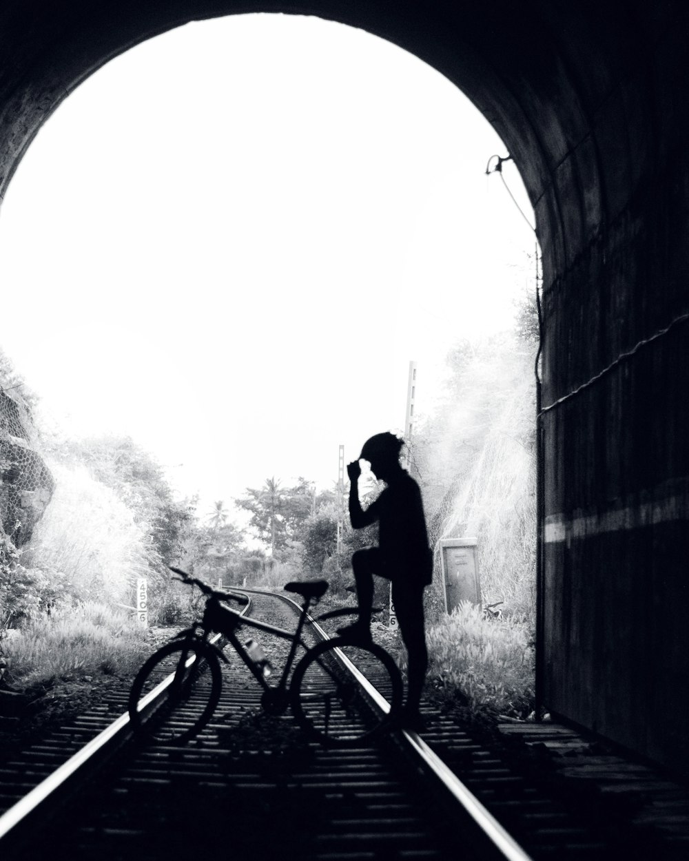 man and woman riding bicycle in tunnel