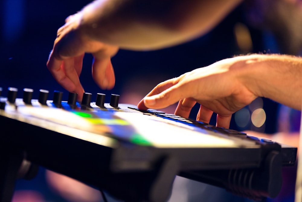 person playing black and white electric keyboard