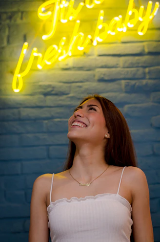 woman in white spaghetti strap top