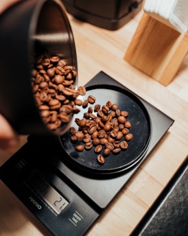 brown coffee beans on black ceramic mug