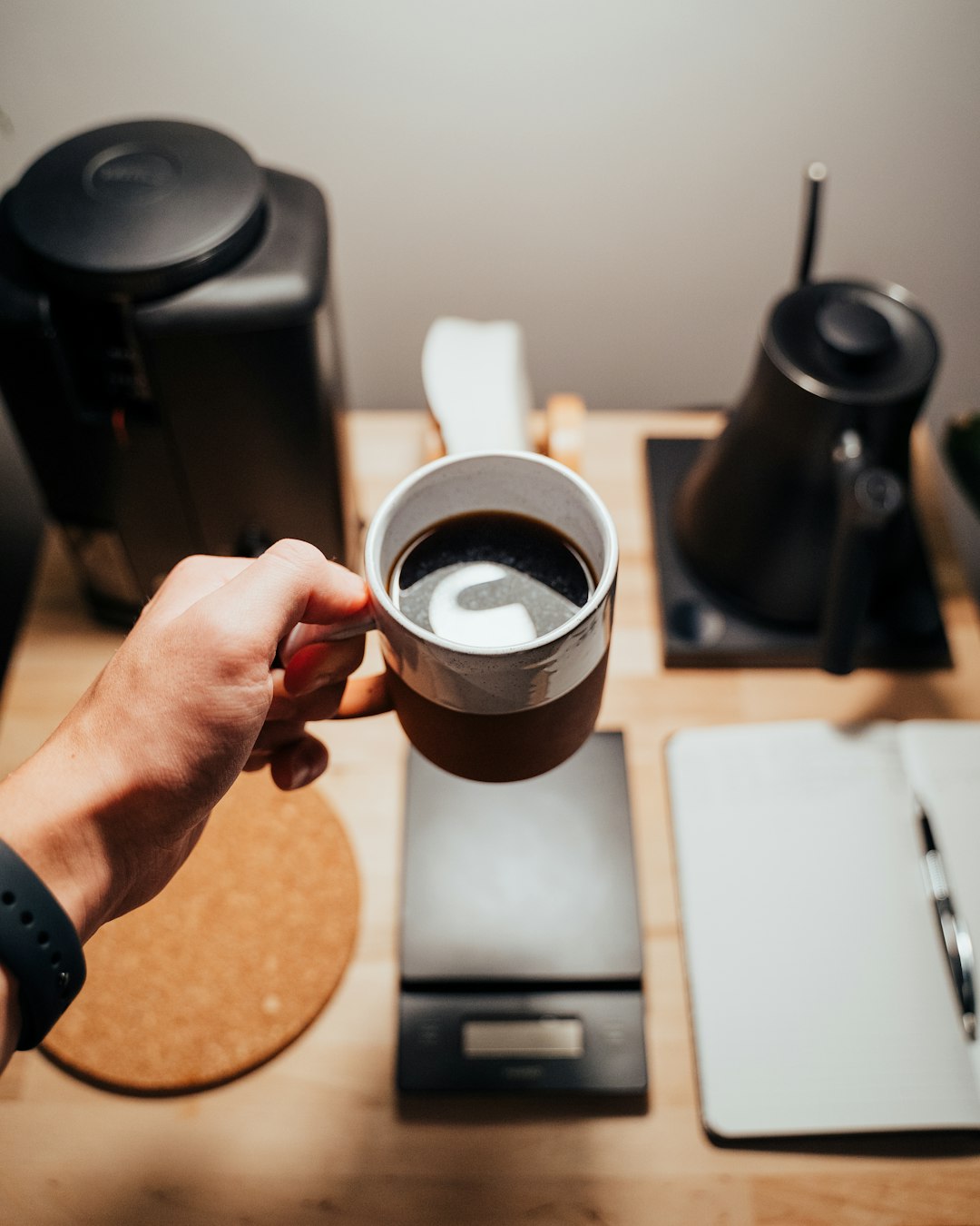 person holding black ceramic mug