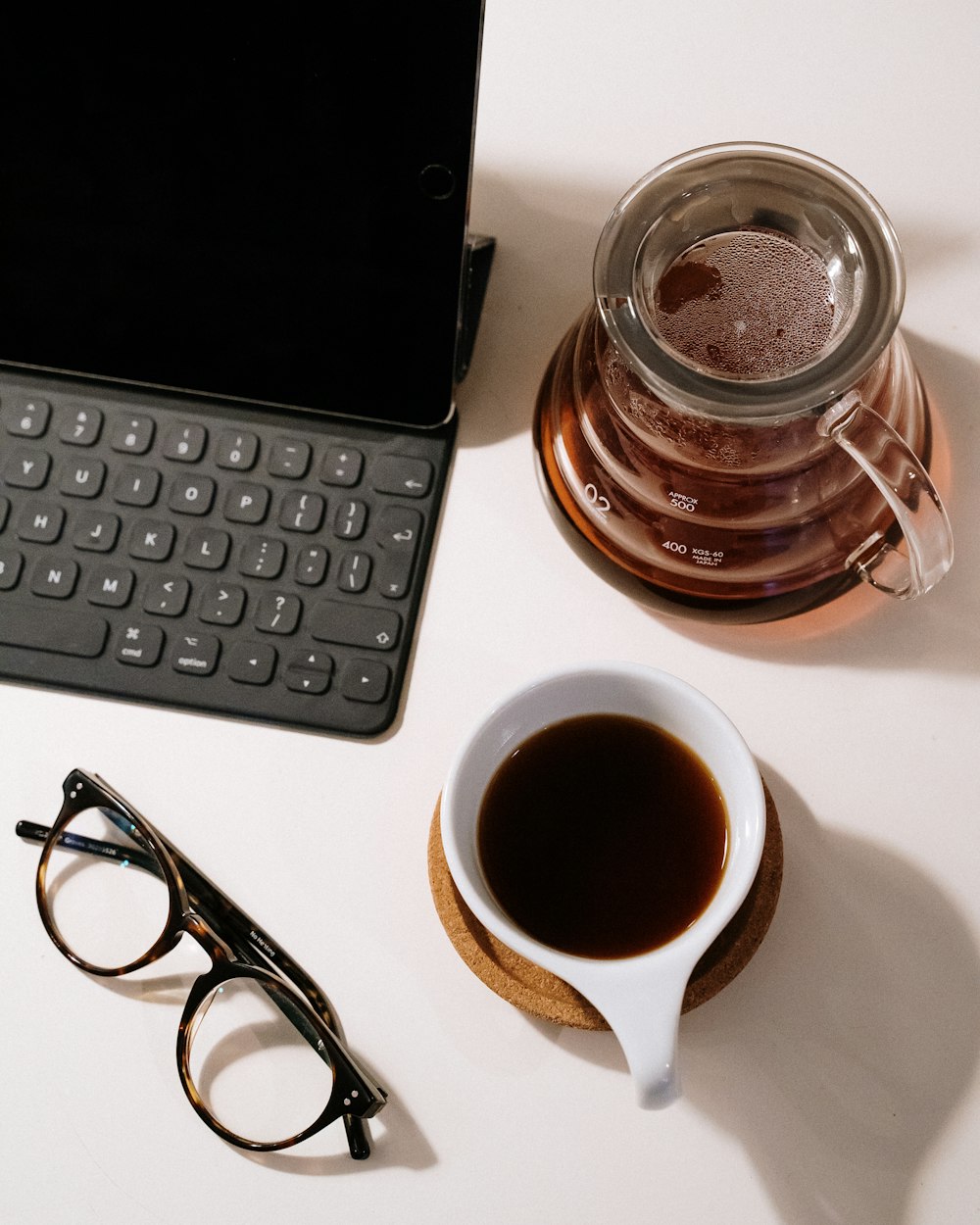 occhiali da vista con montatura nera accanto al computer portatile nero