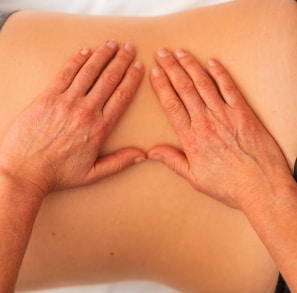persons hand on the abdomen of a patient checking the condition of the patient for the physiotherapy