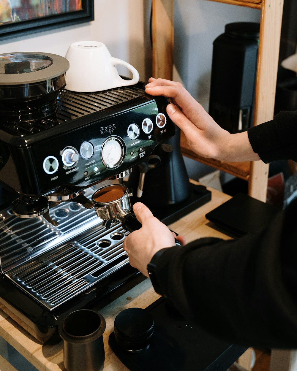 person holding black coffee maker