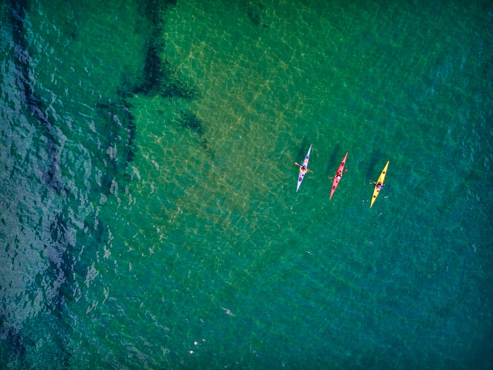 aerial view of people riding boat on sea during daytime
