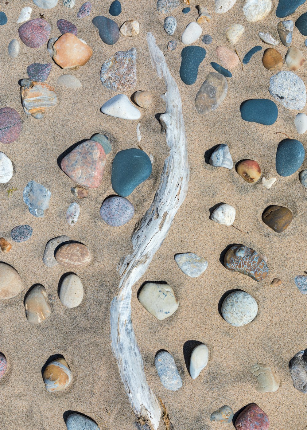 blue and brown stone fragments on beach