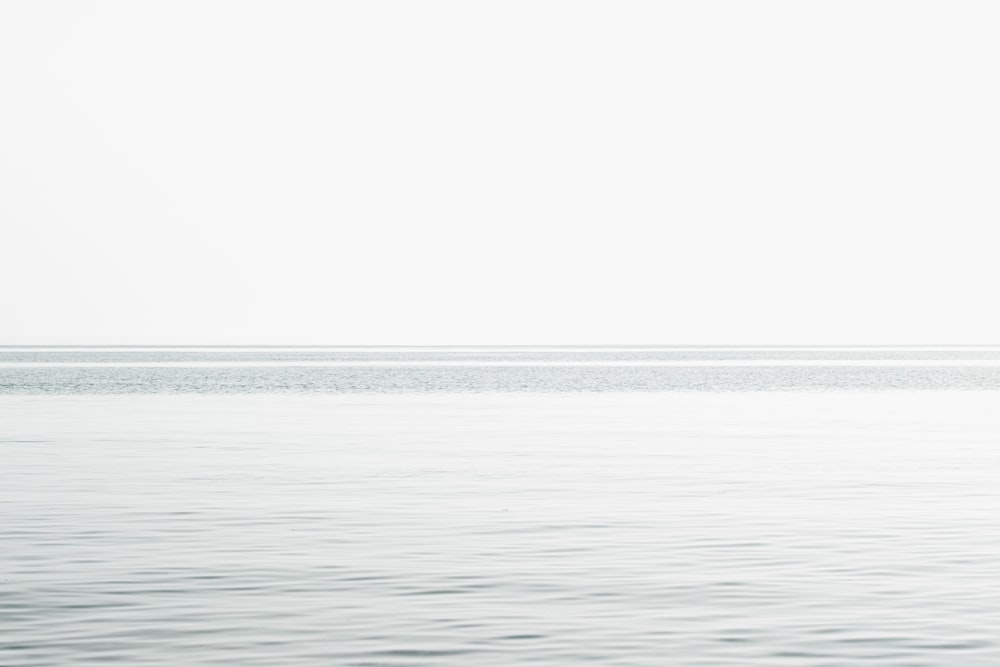 calm sea under white sky during daytime