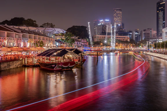 red and brown boat on river during night time