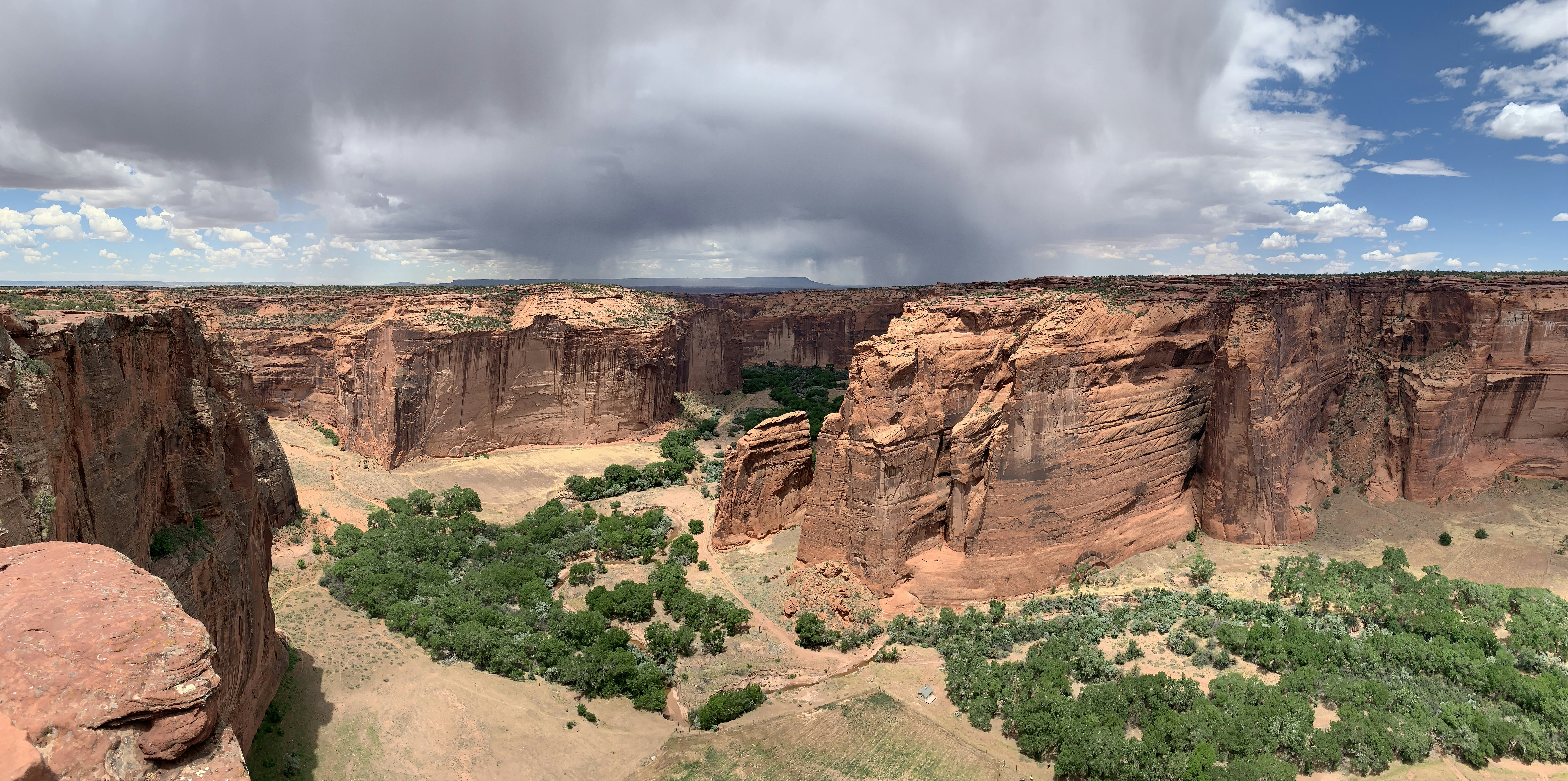 Panoramic image of Canyon de Chelley in Arizona with a threatening Thunderstorm above.