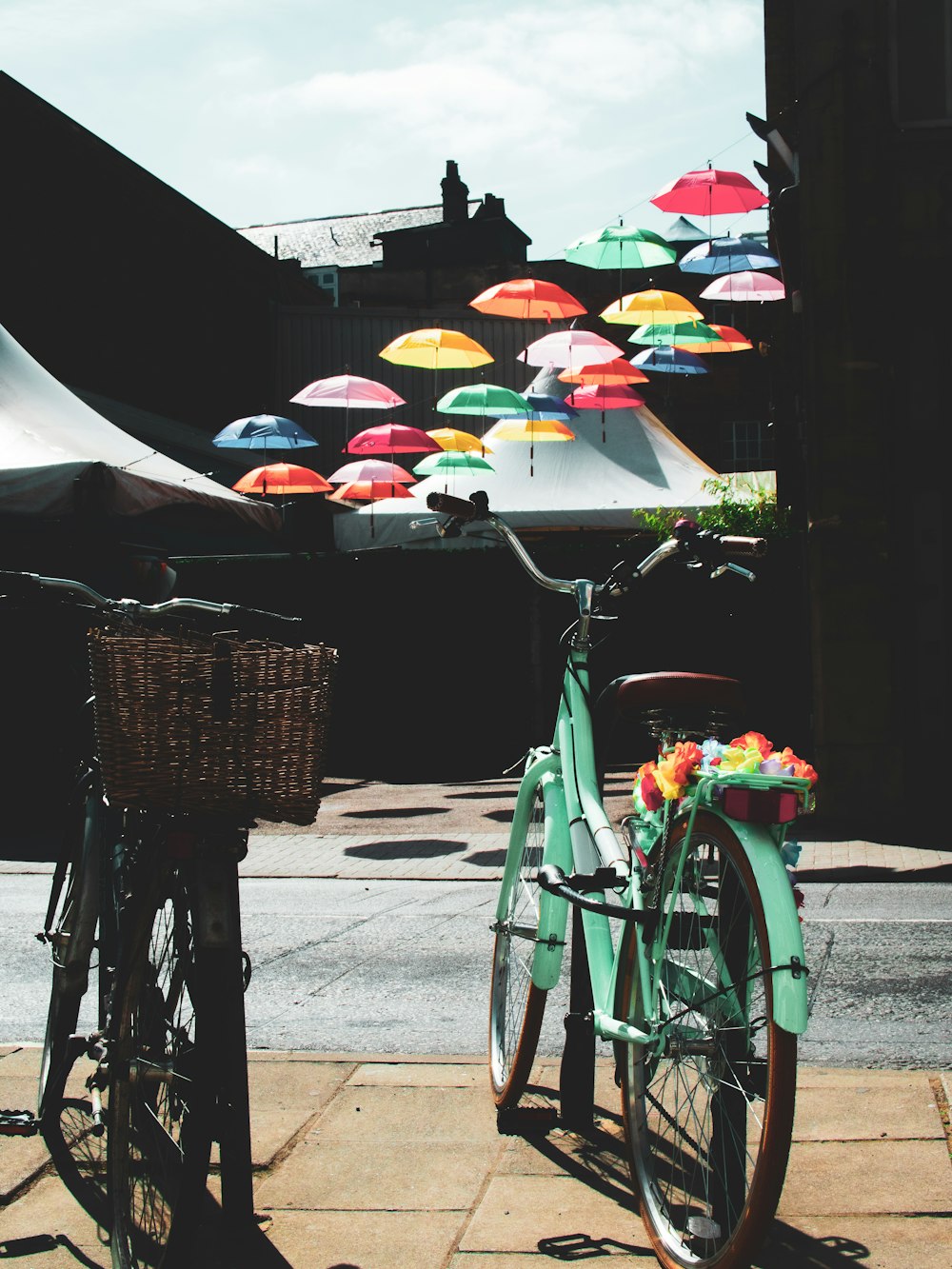 green bicycle with umbrella on the street during daytime