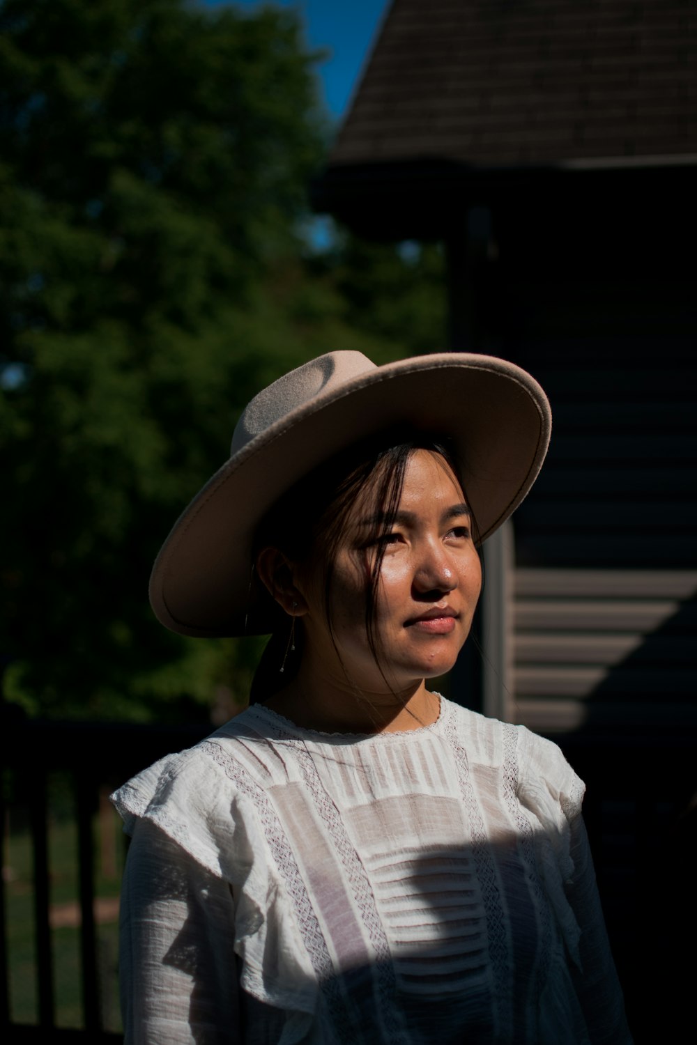 woman in white and gray stripe shirt wearing brown hat