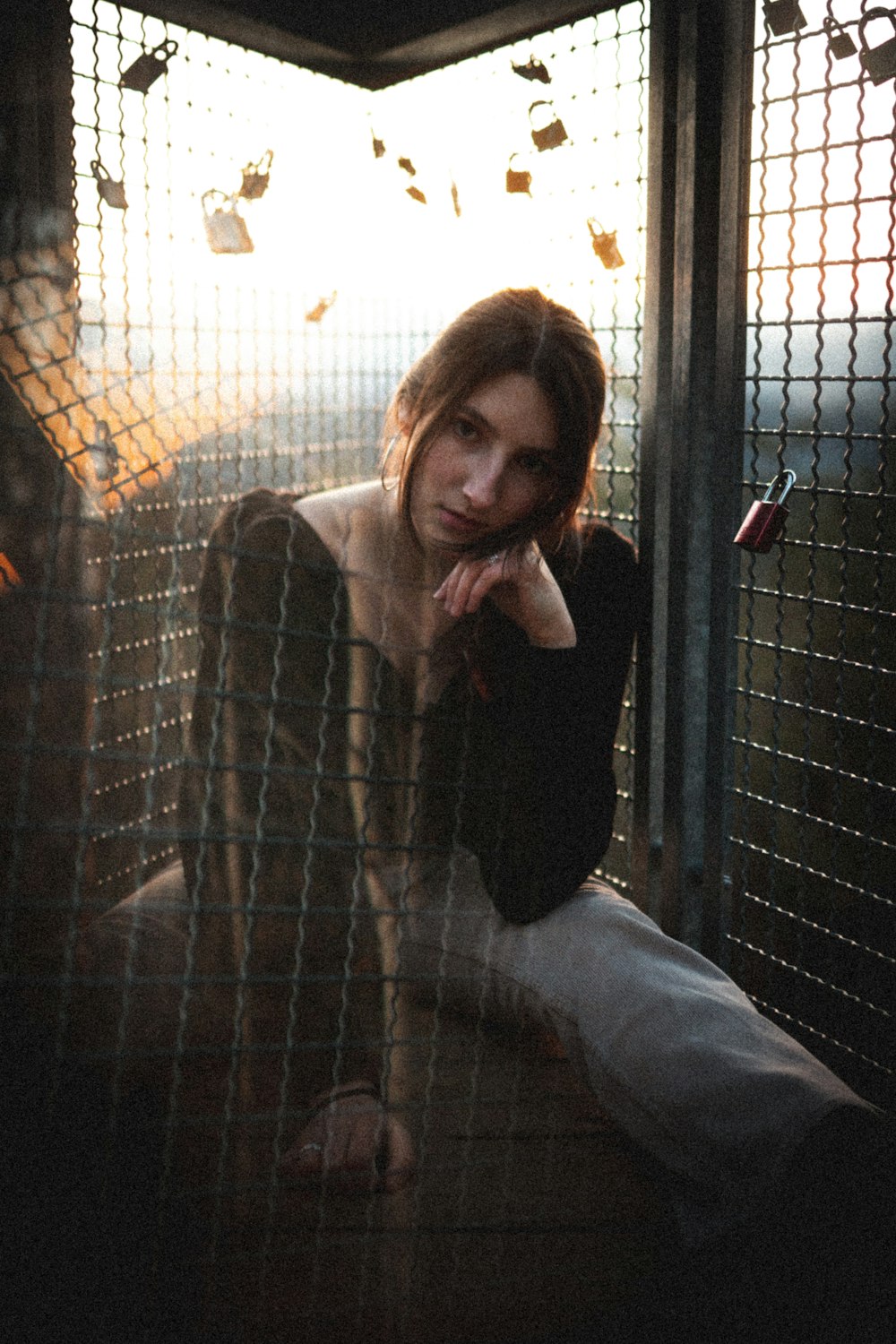 woman in black long sleeve shirt and blue denim jeans sitting on white bed