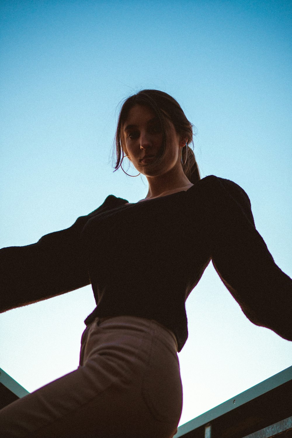 woman in black long sleeve shirt and white denim jeans