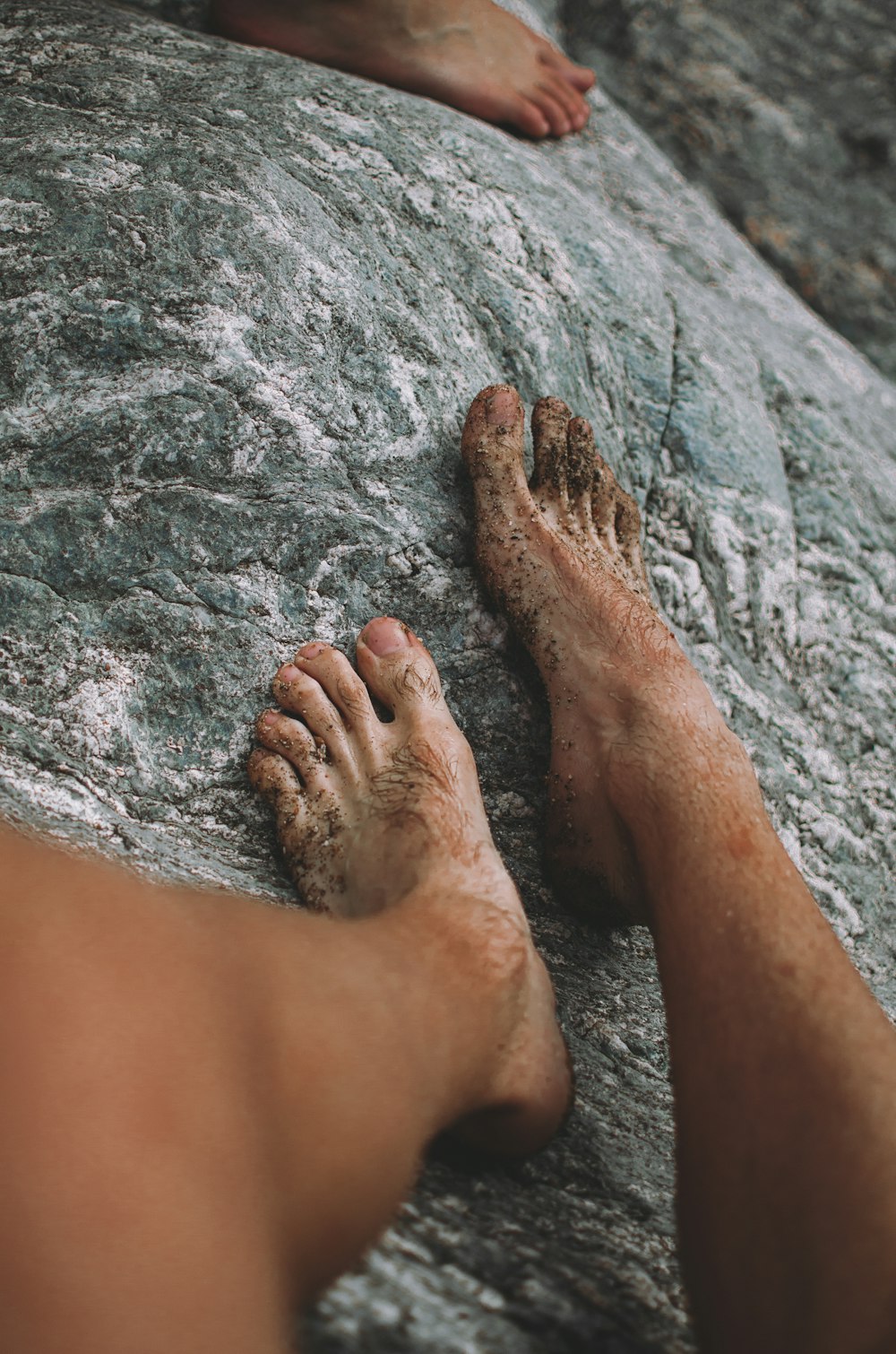 person standing on gray rock