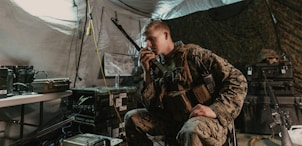 man in brown and black camouflage jacket holding microphone