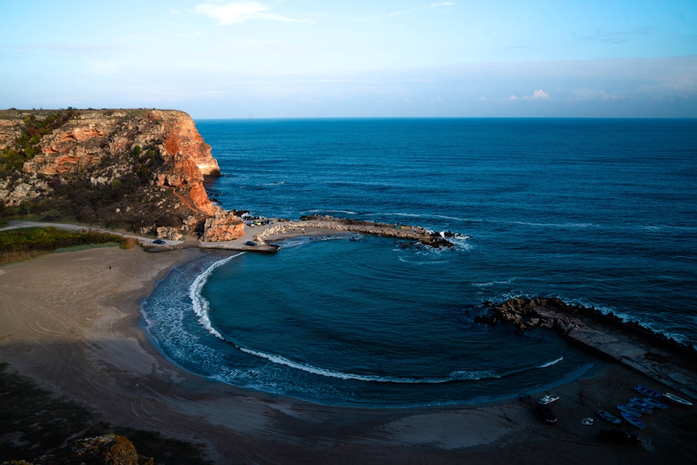 brown rock formation on blue sea water during daytime