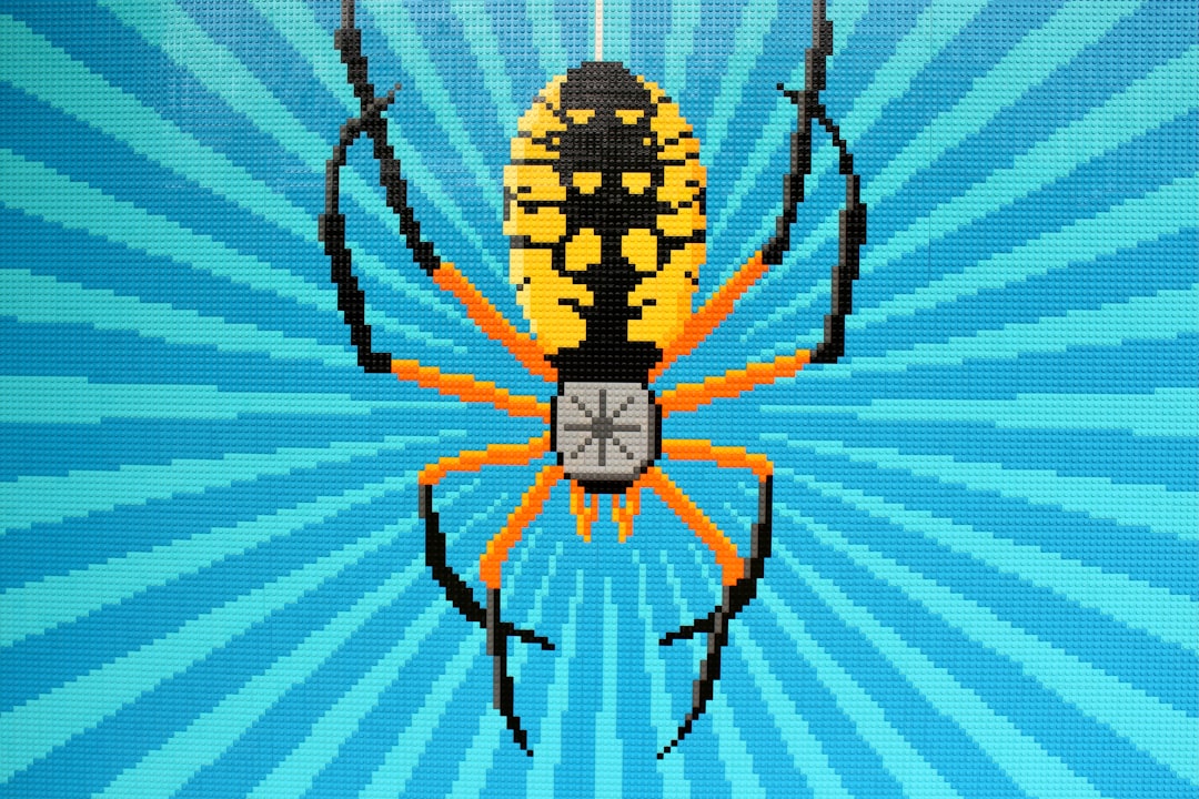 black and yellow spider on white and blue striped textile