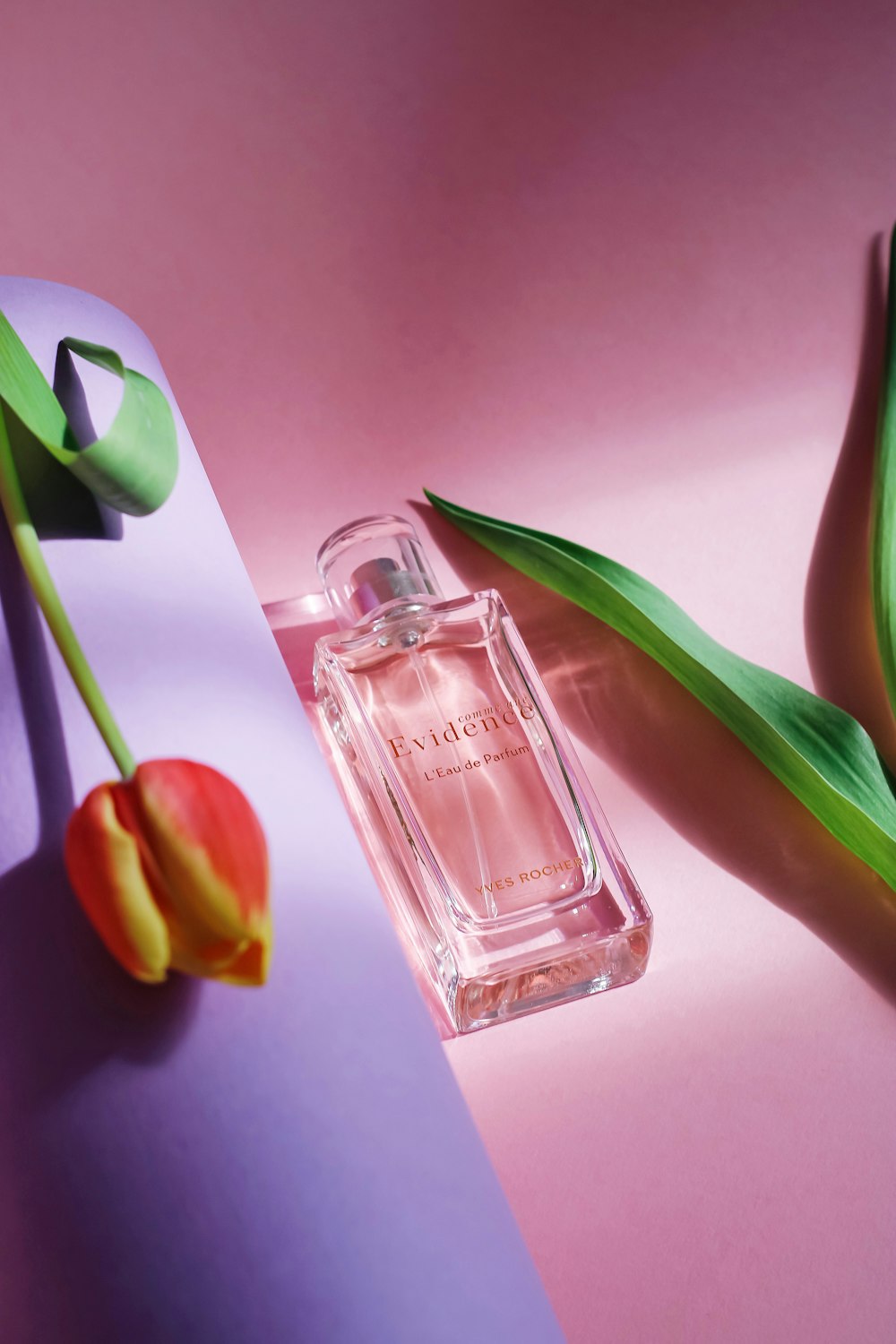 yellow tulips beside perfume bottle