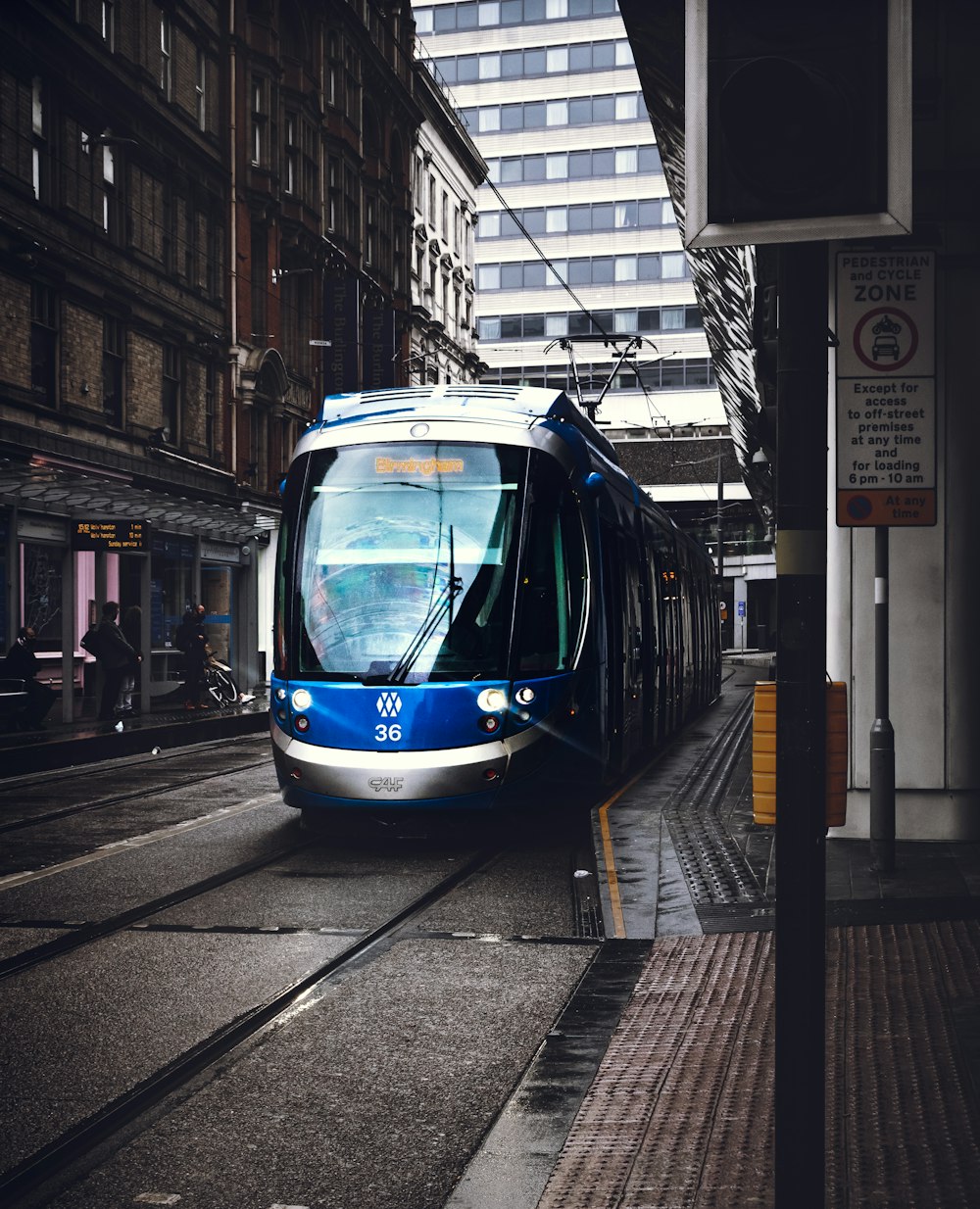blue and white tram on road during daytime