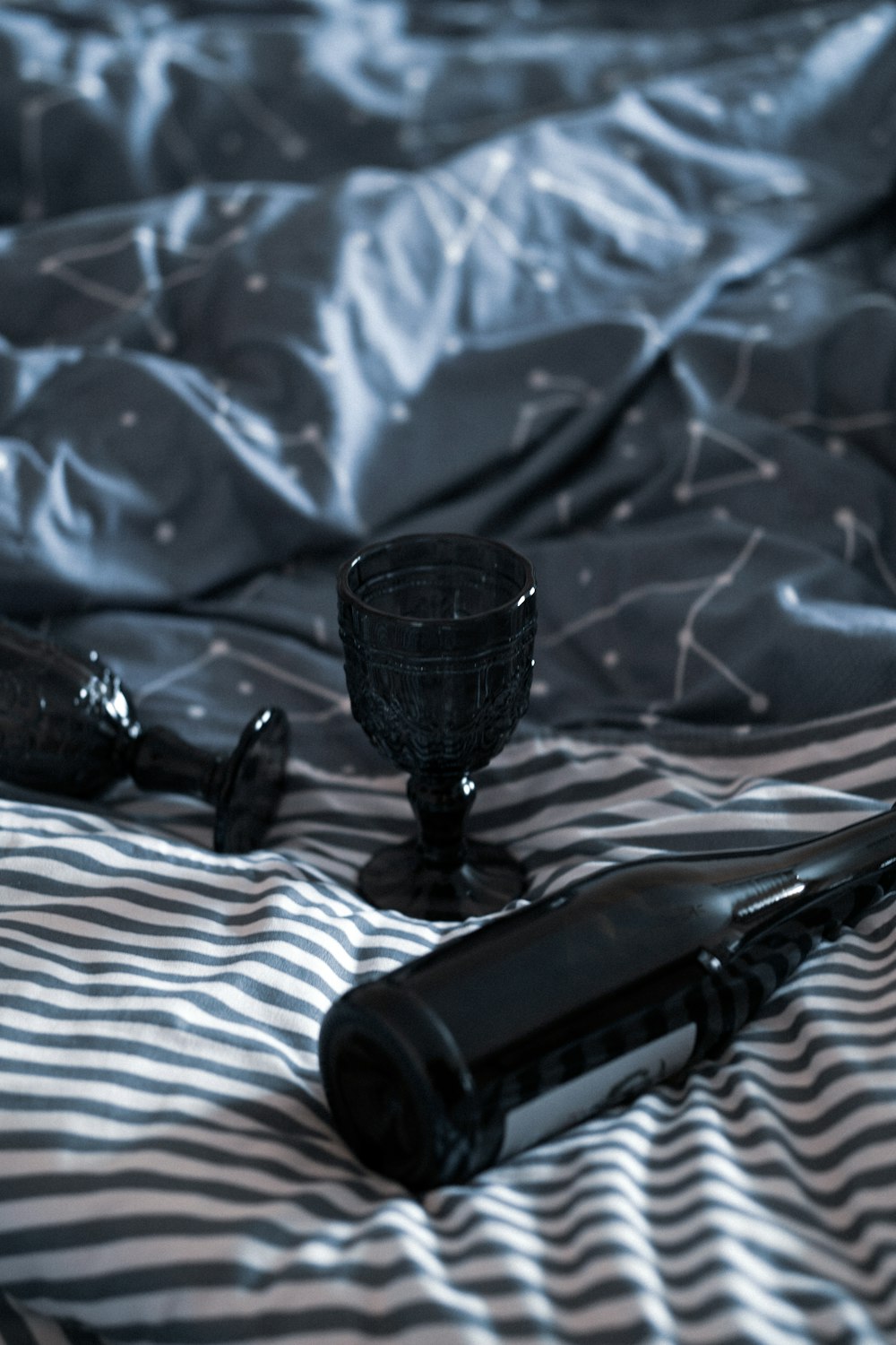 black ceramic footed cup on blue textile