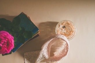 Flat lay of leynds products arranged on soft beige fabric with delicate pink flowers nearby.