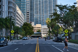cars on road near high rise buildings during daytime