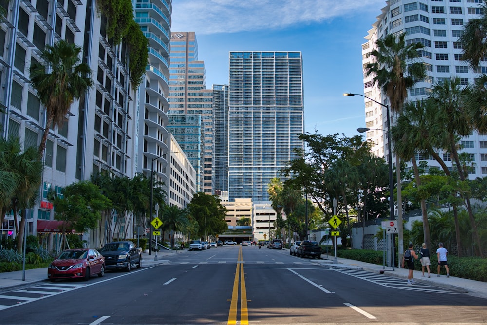 cars on road near high rise buildings during daytime