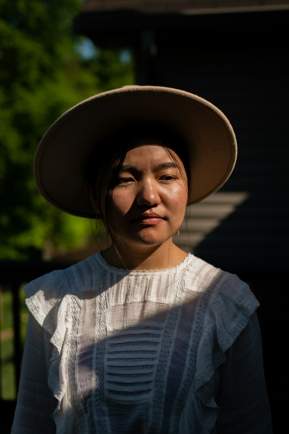 woman in blue and white striped shirt wearing brown fedora hat