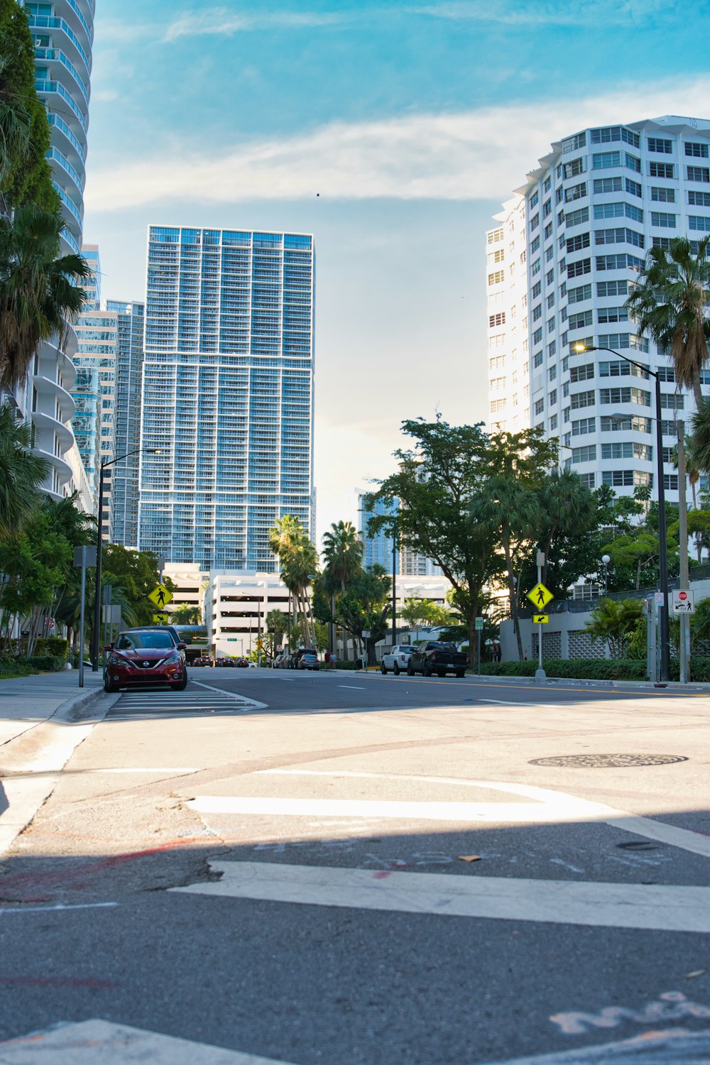 black car on road near high rise buildings during daytime