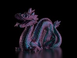 A detailed 3D printed dragon figurine with textured scales.