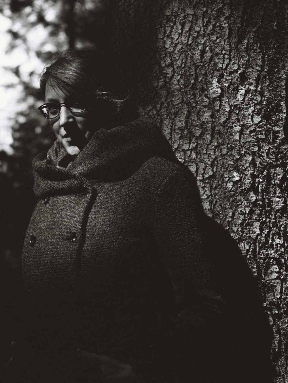 woman in black coat wearing sunglasses