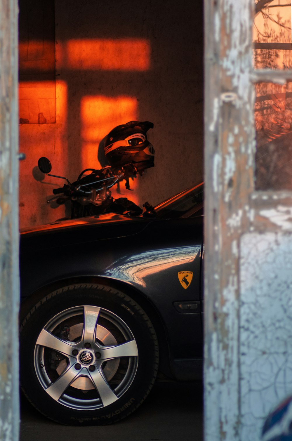 black and brown motorcycle in front of white and brown wall