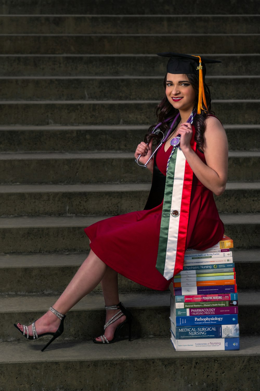 woman in red sleeveless dress standing on stairs