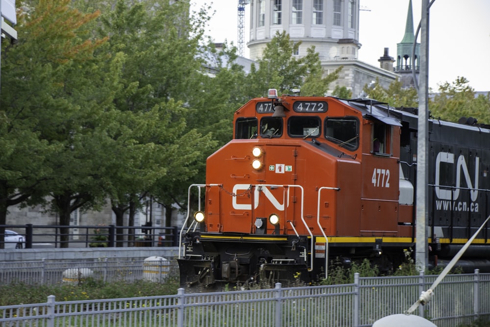 red train on rail road during daytime