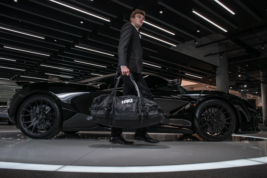 Ays Car Rental chauffeur standing beside a luxury vehicle