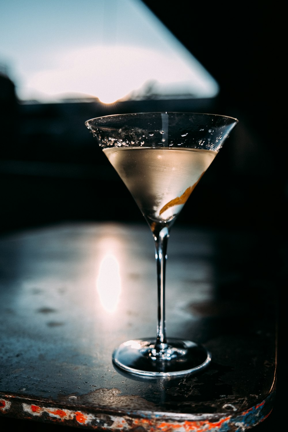 clear martini glass with yellow liquid