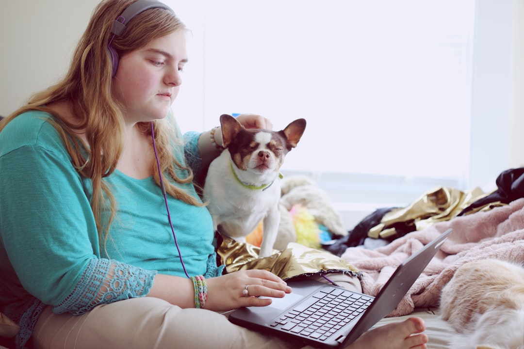 girl in blue jacket holding white and brown short coated puppy, A 19-year-old woman with Autism and other learning disab
