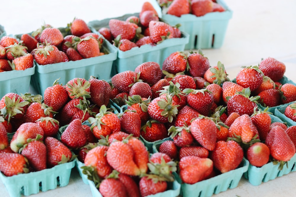 red strawberries on white plastic crate