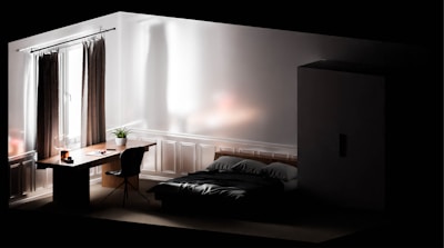 A serene bedroom featuring a stylish bed and minimalist decor.