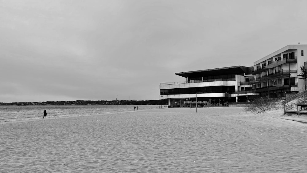 grayscale photo of building on body of water