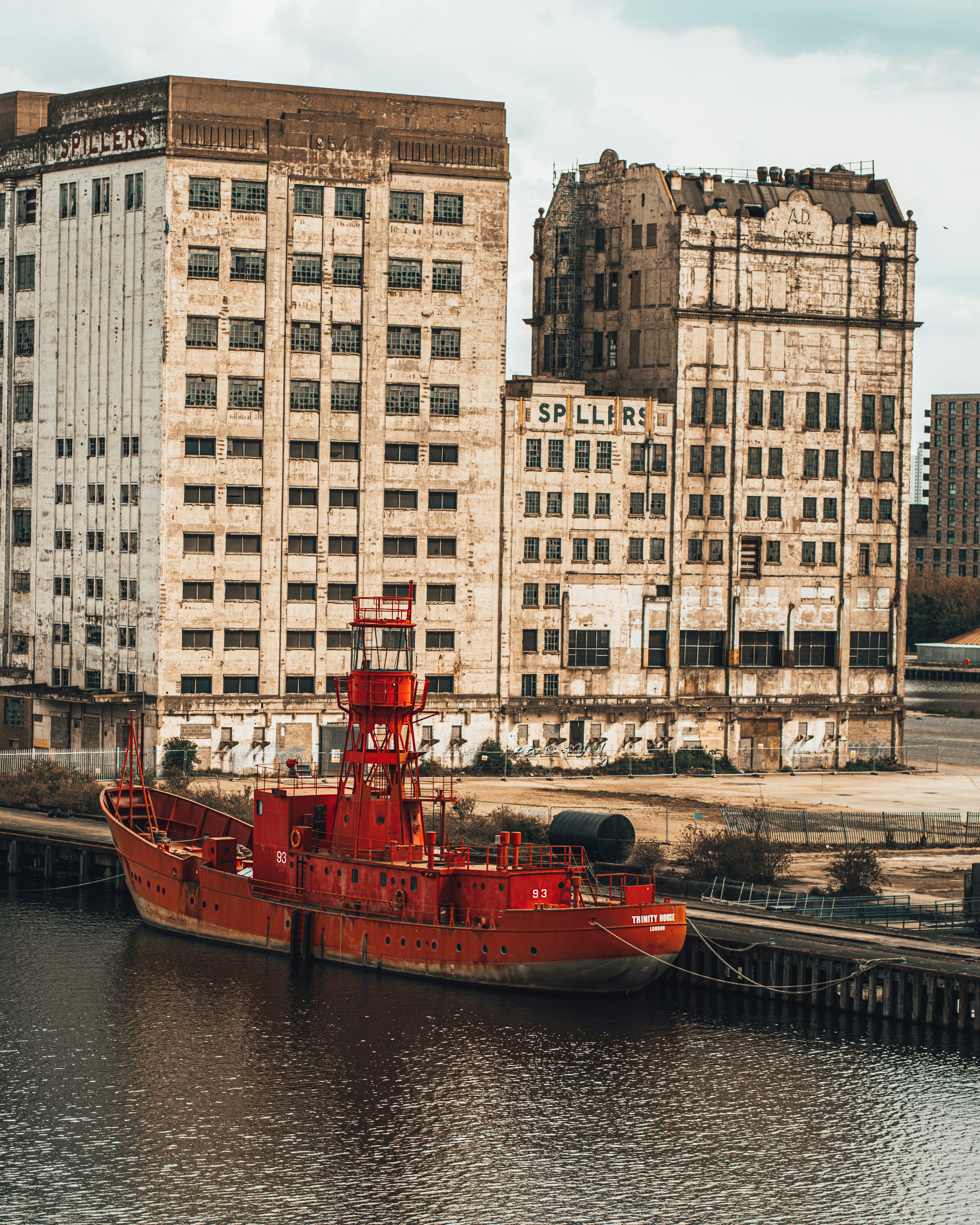 Red and black boat on body of water near high rise buildings during ...