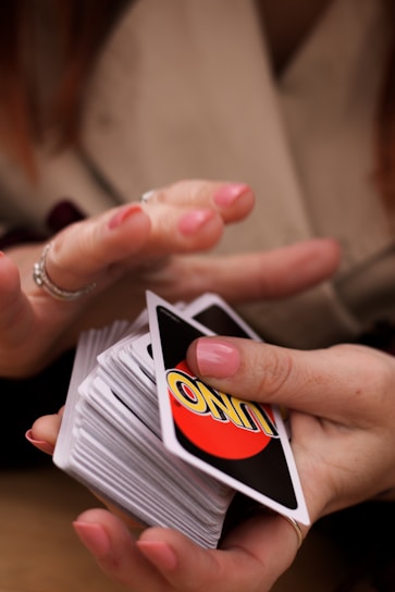 person holding white red and black card
