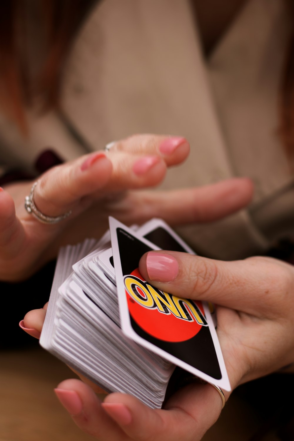 person holding white red and black card