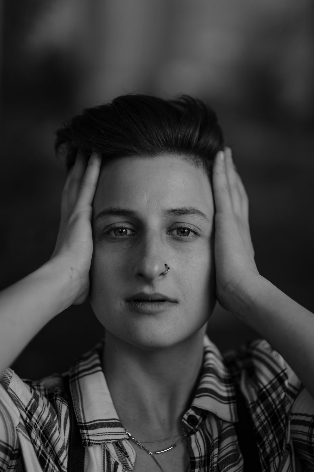 grayscale photo of woman in plaid shirt