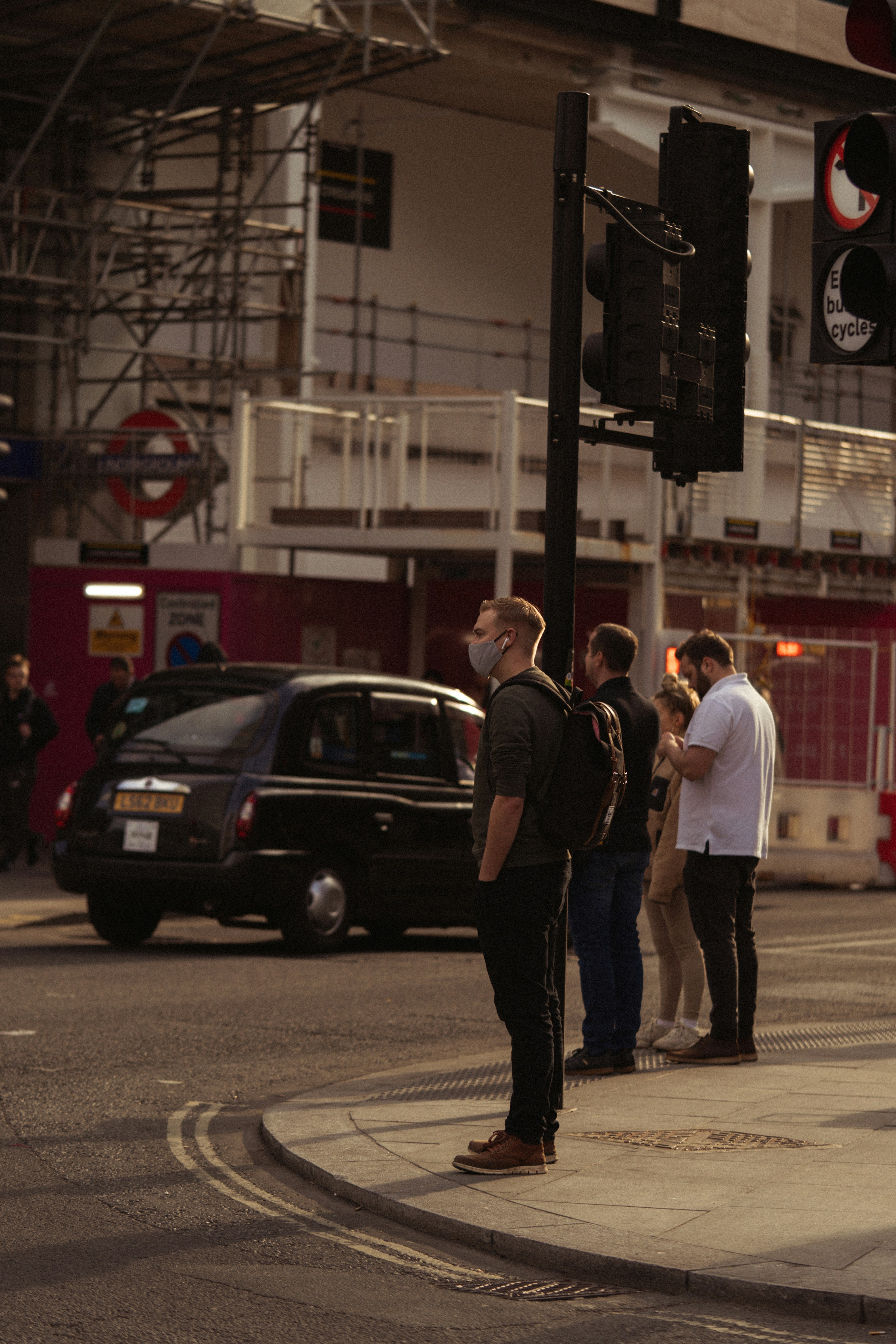 man in black jacket standing beside man in white dress shirt