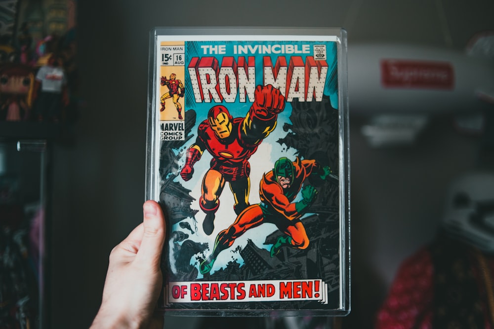 a person holding a comic book in their hand