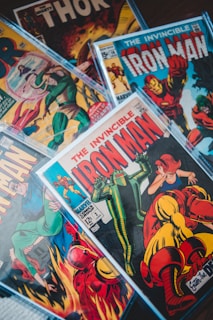 a pile of comics sitting on top of a table